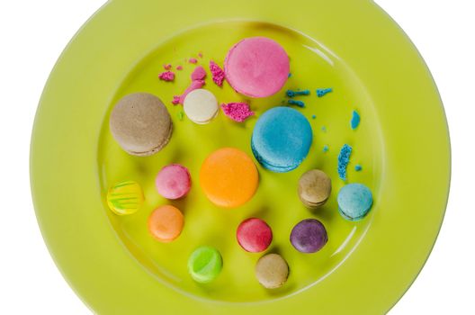 Colorful macaroons collection set on plate over white background
