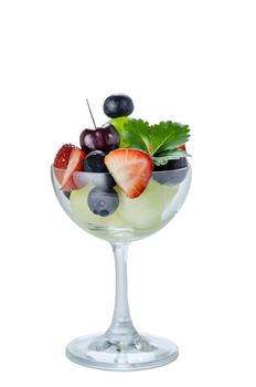 Fresh forest berries and melon  in a glass on a white background isolated