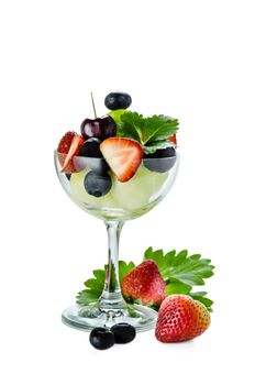 Fresh forest berries and melon  in a glass on a white background isolated