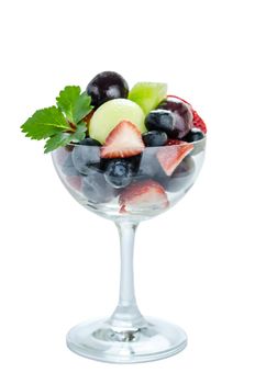 Fresh forest berries and melon  in a glass on a white background isolated