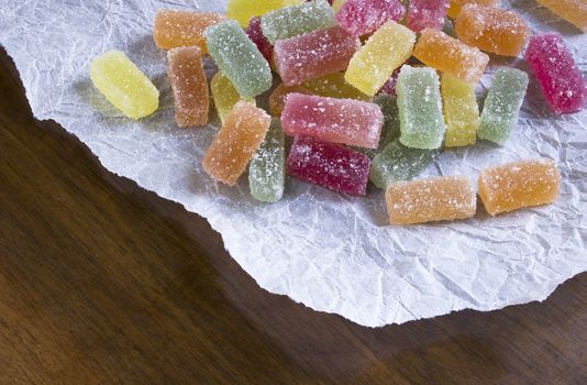 Colorful jelly sugar on the white paper