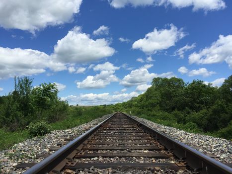 Railway to horizon and clouds on the sky background.