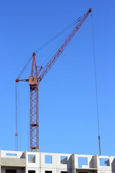 Industrial landscape with silhouettes of cranes on the sky background