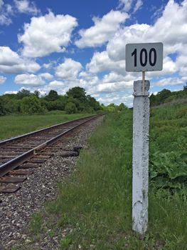 Mile post railway with the number one hundred