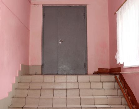 The front metal door with stairs.