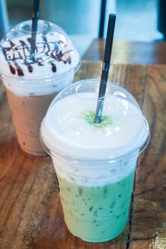 Take-home ice coffee cup on wooden table, stock photo