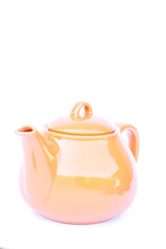 Orange ceramic teapot isolated on white background, stock photo