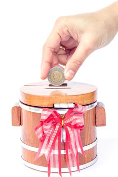 Putting coin to save money, stock photo