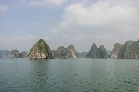 Beautiful limestone mountain scenery panorama of Ha Long Bay, North Vietnam. Cloudy winter weather