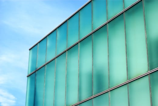 office building glass architecture light green and blue corner and sky business place of work