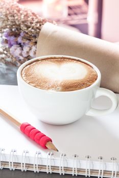 Coffee cup with notepad on grey background, stock photo