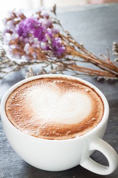 Coffee cup with beautiful violet flower, stock photo