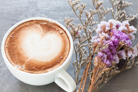 Coffee cup with beautiful violet flower, stock photo