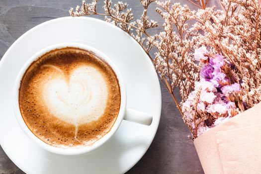 Coffee cup with beautiful violet flower, stock photo