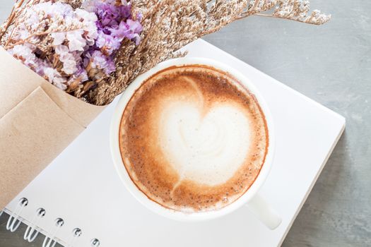 Coffee cup with beautiful violet flower, stock photo