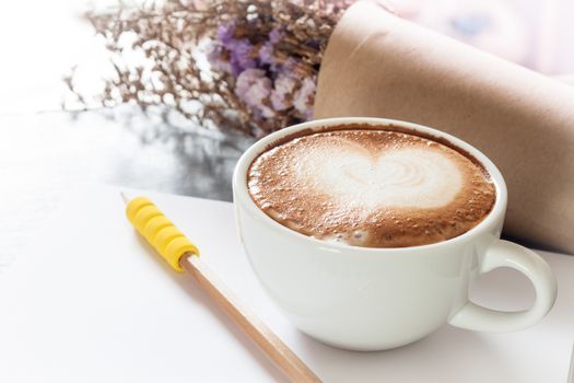 Coffee cup with notepad on grey background, stock photo