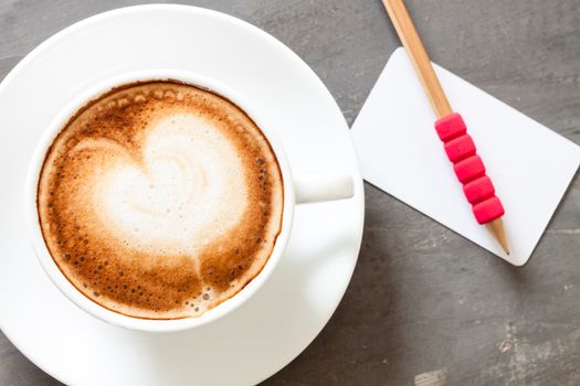 Coffee cup with name card on grey background, stock photo