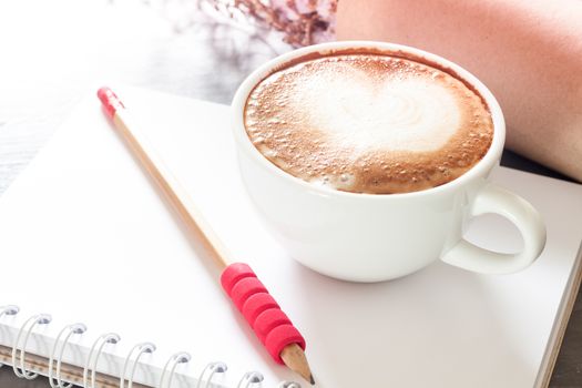 Coffee cup with notepad on grey background, stock photo