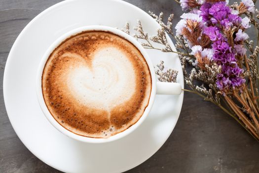 Coffee cup with beautiful violet flower, stock photo
