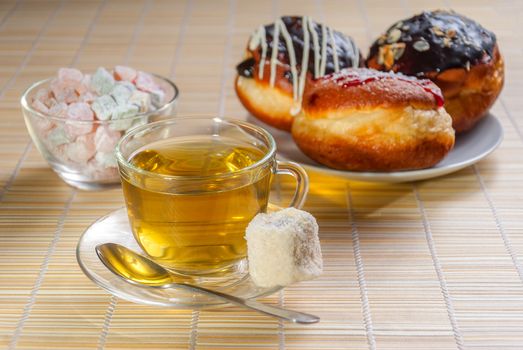 Green tea, fresh cherry muffin, colorful delight and doughnut, sweet dessert