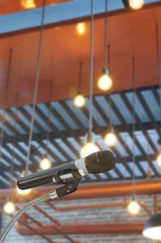 microphone in  hall with lights in background. with 
extremely shallow dof