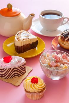 Various tasty sweet dessert with cup of tea