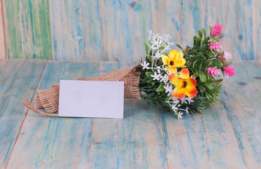 Bouquet of flowers with blank paper tag