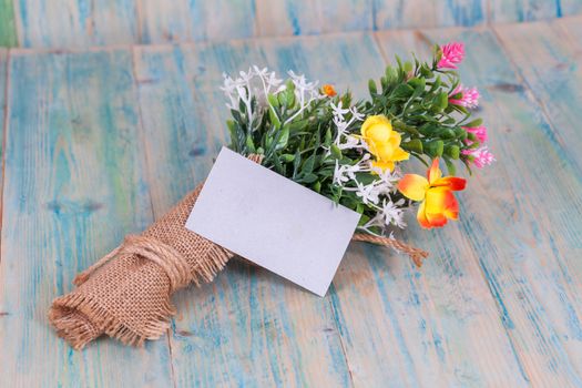 Bouquet of flowers with blank paper tag