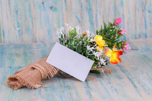 Bouquet of flowers with blank paper tag