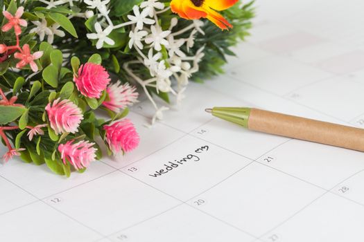 Reminder Wedding day in calendar with pen