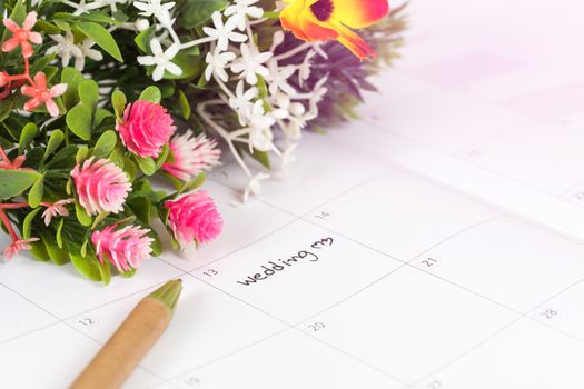 Reminder Wedding day in calendar with pen
