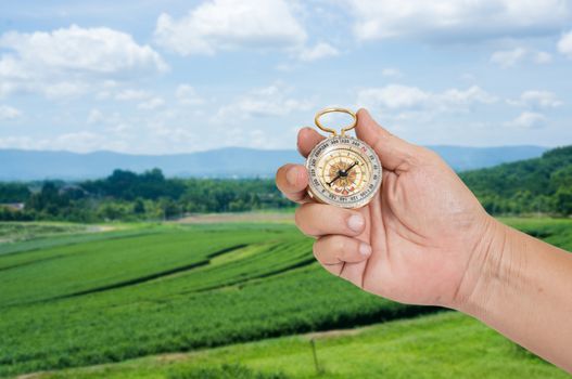 man holding compass in hand