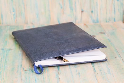 selective focus of the  pen on opened lined diary book , 
extremely shallow DOF
