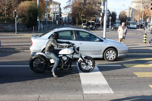 Zurich, Switzerland - November 27, 2011. Motorcyclist biker stopped at an intersection