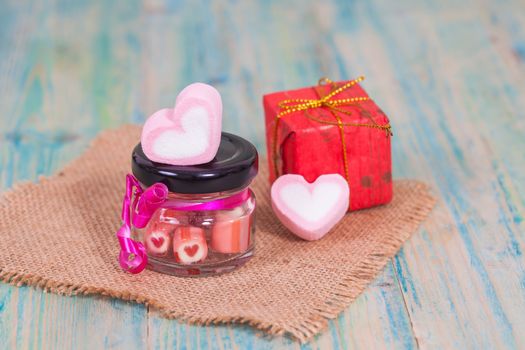 candies sweets heart in bottle on table
