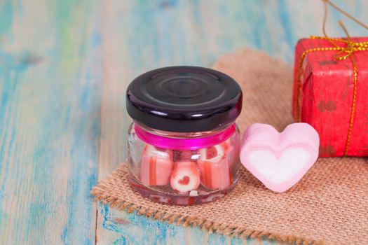 candies sweets heart in bottle on table