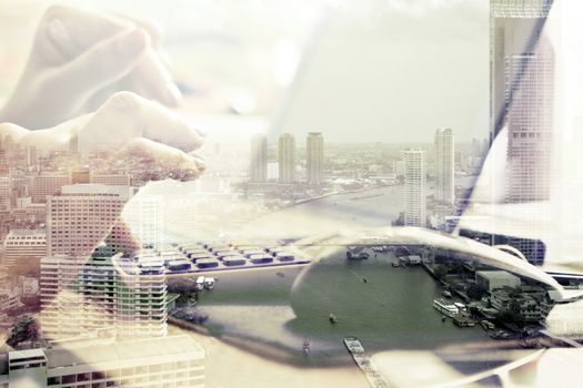 Double exposure image of woman using computer and cityscape background,Computer networking concept.