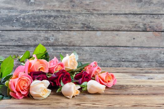 Beautiful roses on old wooden table