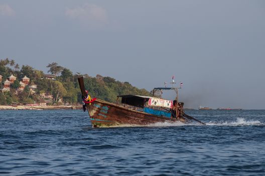 Kho Phi Phi, Thailand - August 2, 2010: Longboat at bay of Phi Phi island, Krabi province, Thailand