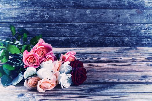 Vintage beautiful bouquet of flowers roses on rustic wooden table