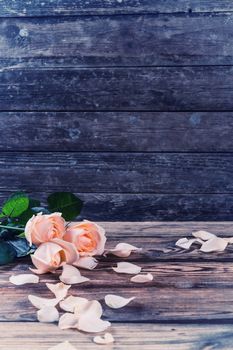 Vintage beautiful roses on wooden table, rustic style