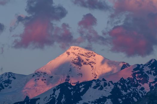 Big mountains in clouds on sunset