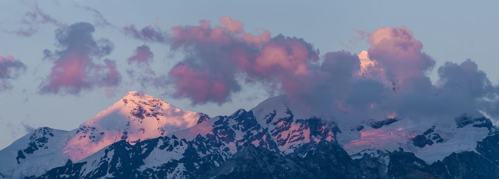Big mountains in clouds on sunset