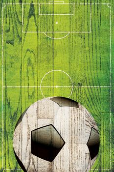 A soccer ball and field painted over a hard wood plank background.
