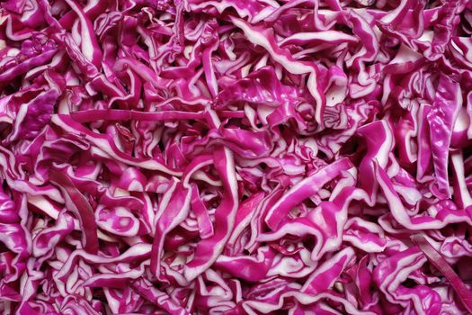 Shredded raw red cabbage as an abstract background texture