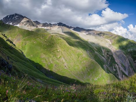 Beautiful landscape with mountain peaks and meadows