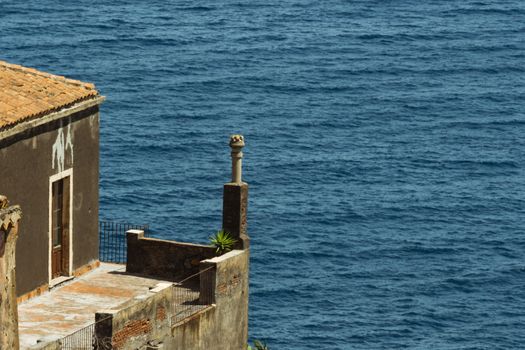 detail of an ancient Italian house over the blue sea