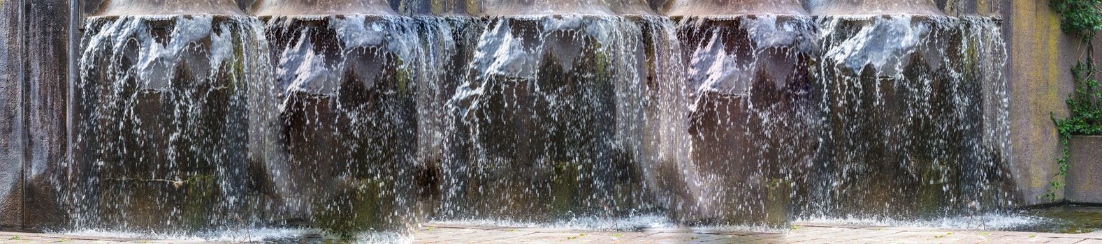 Panorama Artificially designed waterfall, fountain - Fountain in a park.