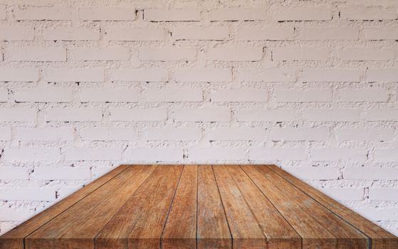 Perspective wooden table top with brick wall decorated in coffee shop