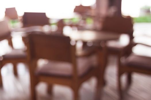 Coffee shop blur backgroun with wooden table, stock photo
